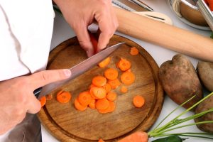 Green House Homes - chef cutting carrots